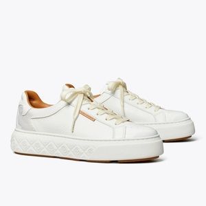 cream/off white leather Tory Burch Sneakers with brown trimming, and tan laces.